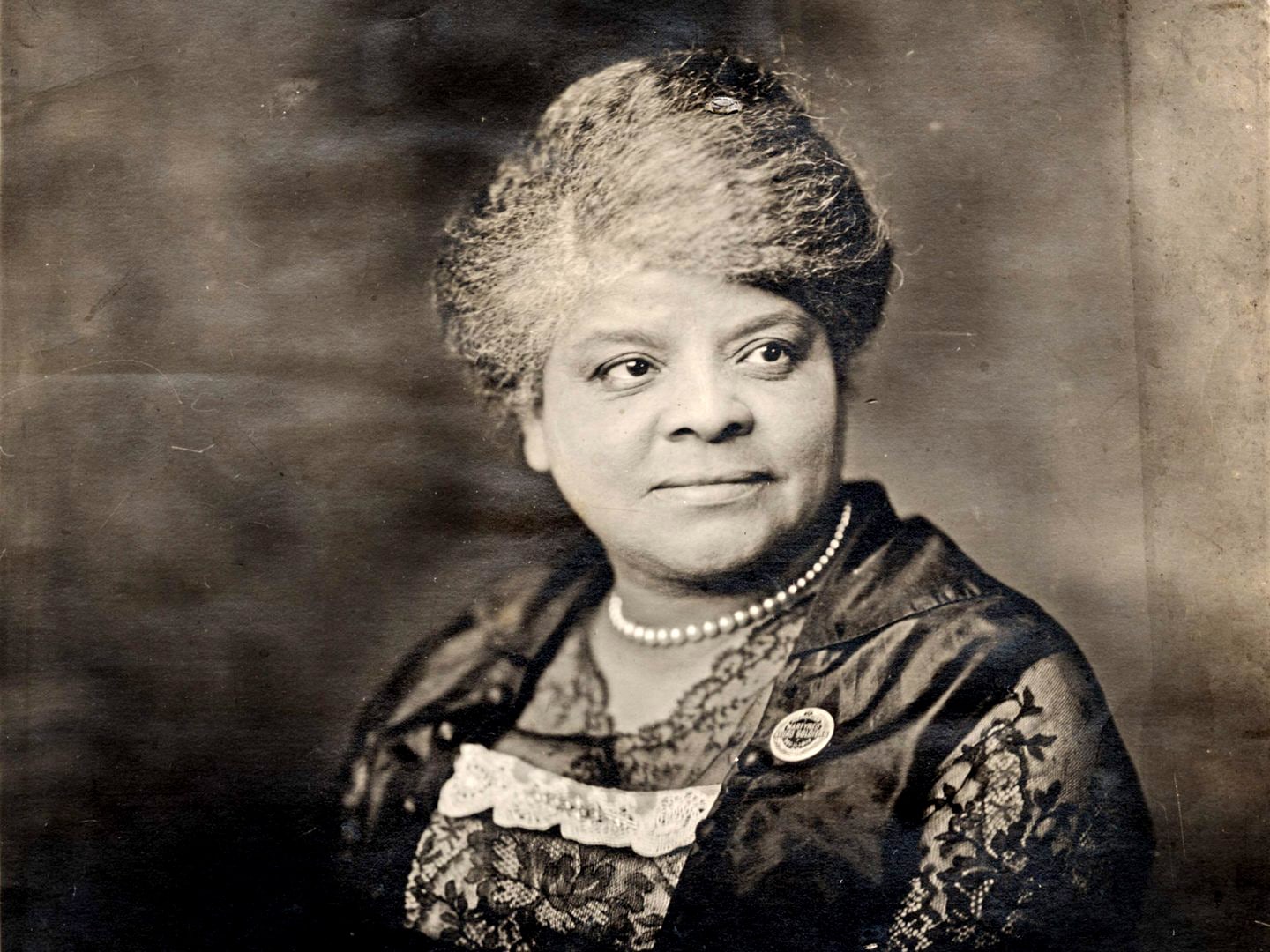 Photo of Ida B. Wells wearing an organizing button